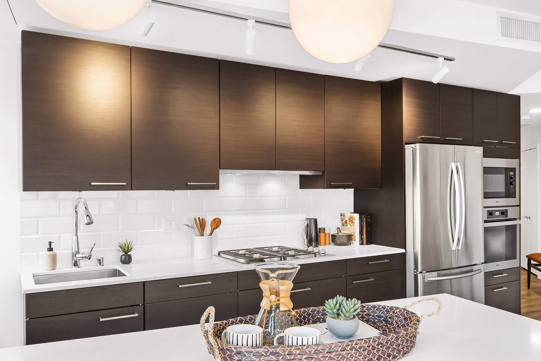 Modern kitchen with stainless steel appliances and sleek countertops at The Goodwin Apartments