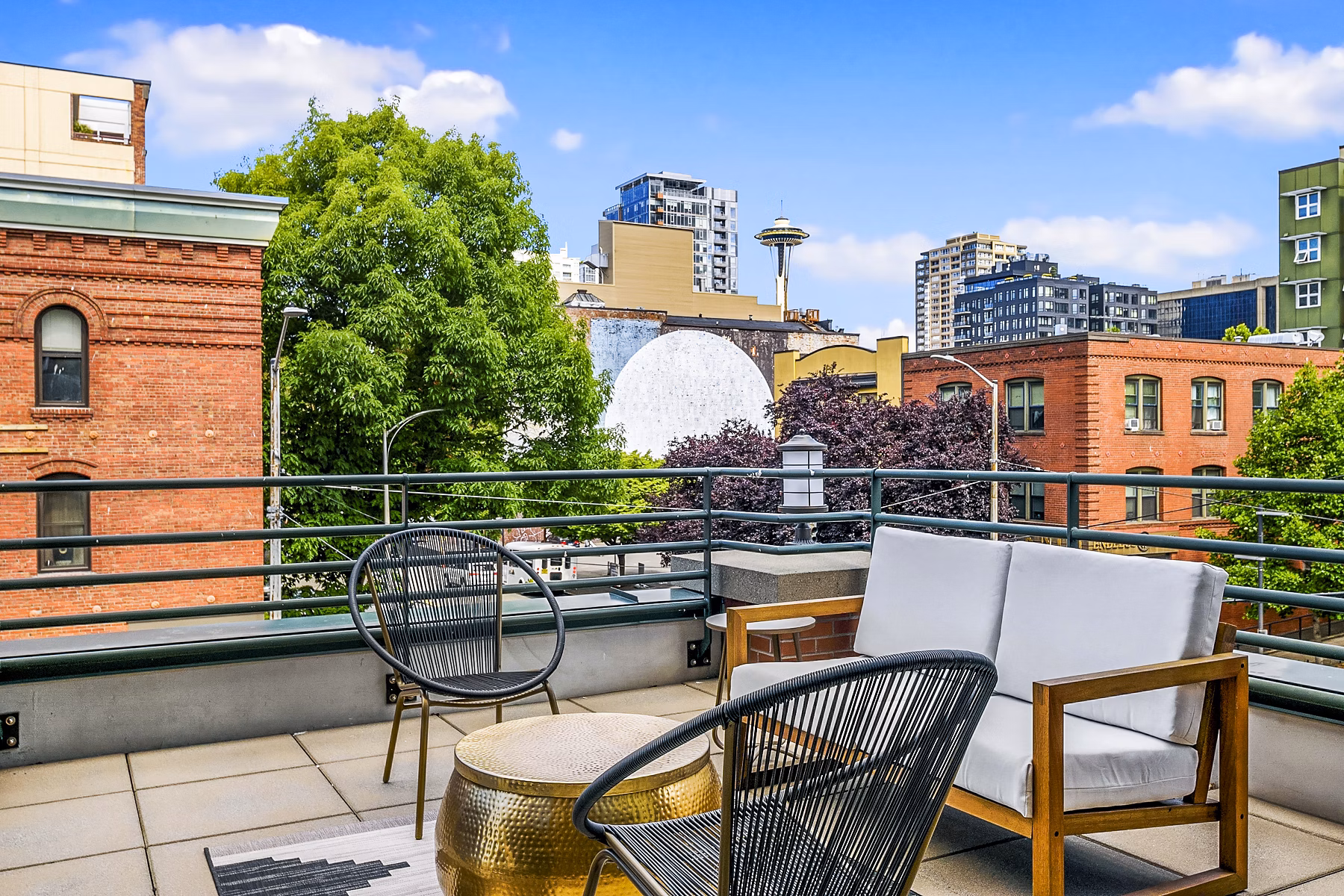 The Goodwin Apartments: Stylish patio with outdoor seating and greenery