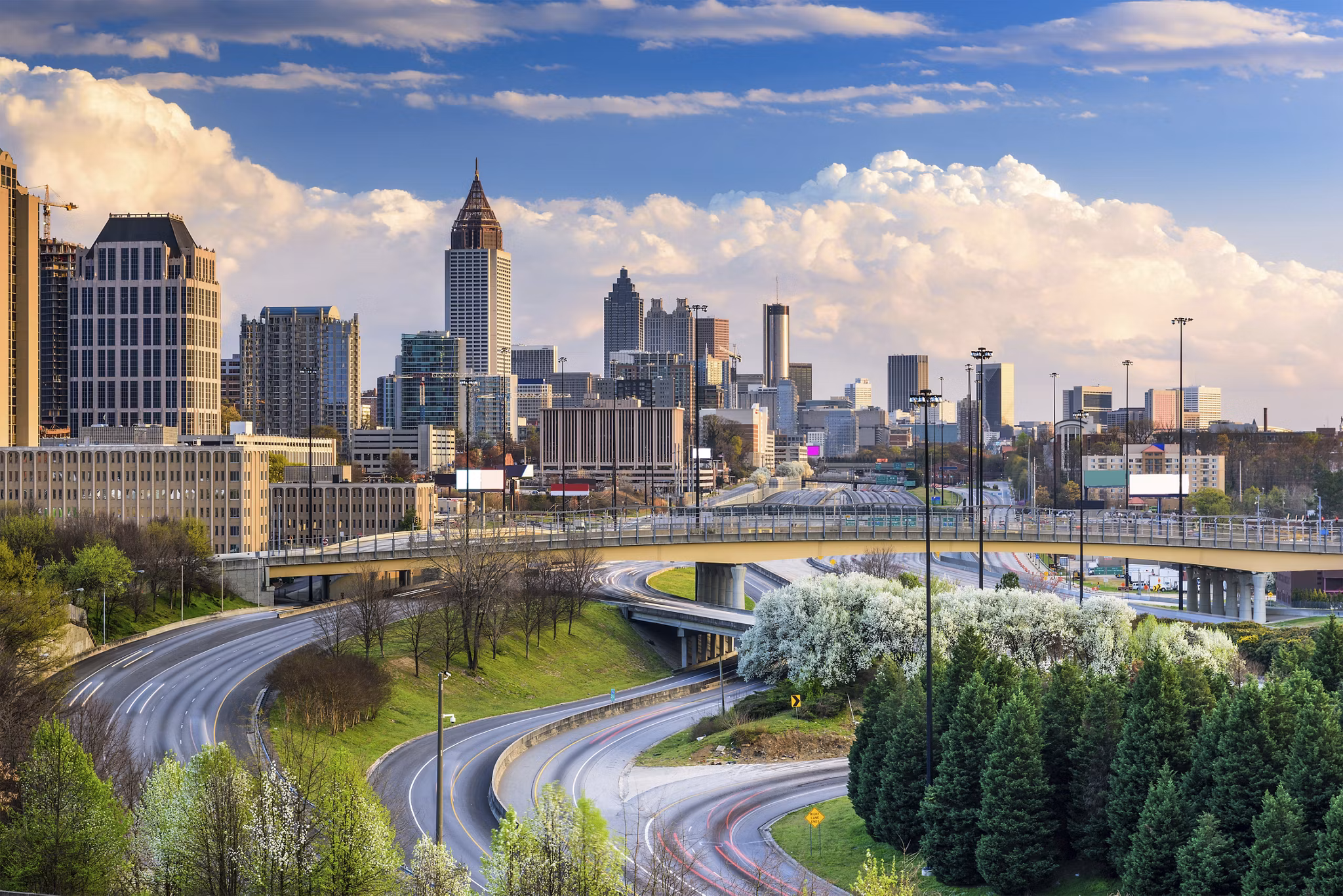 Lindridge-Martin Manor/Lindbergh, GA with highways, blooming trees, and Atlanta skyline featuring Bank of America tower.